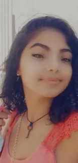 Mobile wallpaper featuring a woman with curly hair and a warm smile.