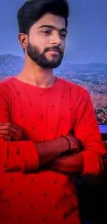 Young man in red shirt with scenic background wallpaper.