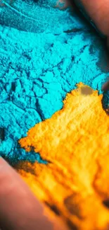 Vibrant blue and orange powder art mobile wallpaper.