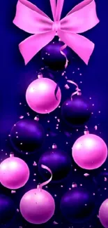 Purple Christmas tree with pink ornaments and a bow.
