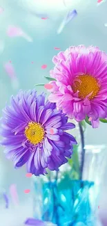 Purple and pink daisies in a vase with petals in the air.