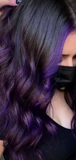 Woman with vibrant purple hair in stylish curls, wearing a mask.