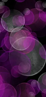 Vibrant purple orbs on a dark background mobile wallpaper.