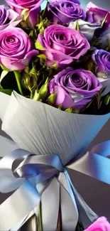 Bouquet of vibrant purple roses tied with a silver ribbon.