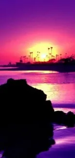 Purple sunset with ocean and palm tree silhouettes.