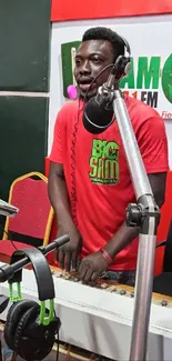 Radio host with headphones in vibrant studio setting.