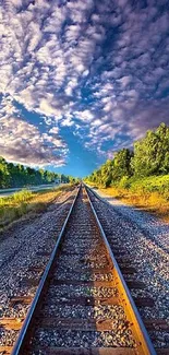 Scenic railway track with cloudy sky and greenery on a mobile wallpaper.