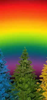 Colorful Christmas trees beneath a vibrant rainbow sky wallpaper.