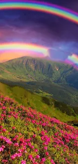 Vibrant rainbow over mountains with flowers in foreground, colorful nature scene.