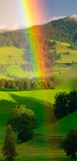 Rainbow stretches over lush green hills in a scenic landscape.