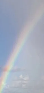 Vibrant rainbow stretching over a calm ocean.