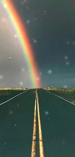 Rainbow arches over a straight road, under a dark sky.