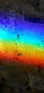Vibrant rainbow against a textured stone background for mobile wallpaper.