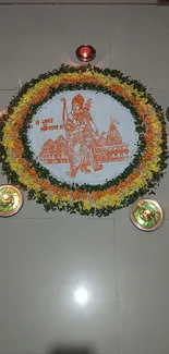 Traditional rangoli design with candles on a tiled floor.