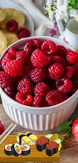 Red raspberries in a bowl with sushi illustration on a wooden table.