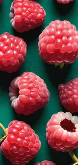 Ripe raspberries scattered on a green background.
