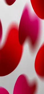 Vibrant red and pink abstract wallpaper with fluid shapes and gradients.