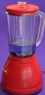 Red blender on a vibrant purple background, stylish and modern.