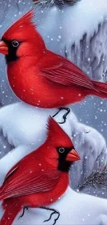 Two red cardinals on snowy branches, creating a winter scene.