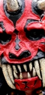 Vibrant red demon mask with intricate details for mobile wallpaper.