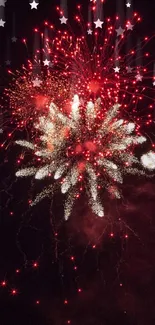 Vibrant red fireworks exploding in night sky.