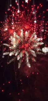 Vibrant red fireworks illuminating the night sky.