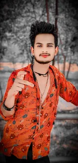 Man in vibrant red floral shirt with artistic background.