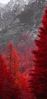 A vibrant red forest with mountains in the background and a winding road.