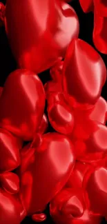 Glossy red 3D hearts on a black background.