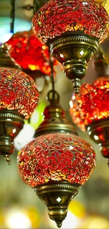 Mobile wallpaper of vibrant red mosaic lanterns casting a warm glow.