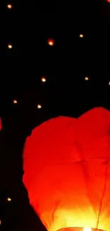 Mobile wallpaper featuring glowing red lanterns against a dark night sky.