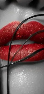 Close-up of wet red lips with black strands on a mobile wallpaper.