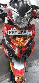 Vibrant red motorcycle with Manchester United emblem design.