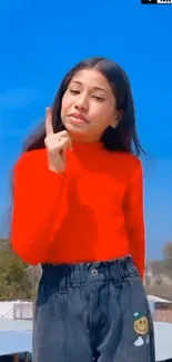 Young girl in red top with sky background.