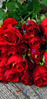 Vibrant bouquet of red roses on wooden background.