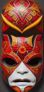 Vibrant tribal mask wallpaper with red and geometric patterns.