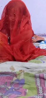 Vibrant red veil on a colorful bedspread.