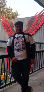 Person poses with vibrant red wings in an urban outdoor setting.