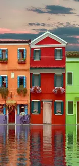 Colorful houses reflecting in water with a dramatic sky.