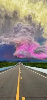 Vibrant road leading to a colorful, dramatic cloudscape under an open sky.