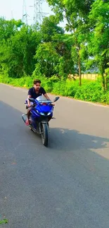 Biker on a green road with lush nature surrounding the path.