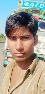 Vibrant roadside selfie with colorful truck and clear blue sky.