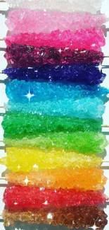 Colorful rock candy sticks arranged horizontally on a white background.