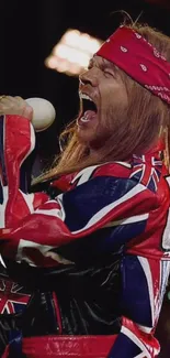 Dynamic singer on stage in Union Jack attire with a red bandana.