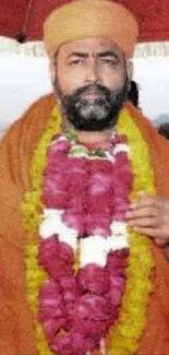 Sage in orange robe under a vibrant umbrella procession.