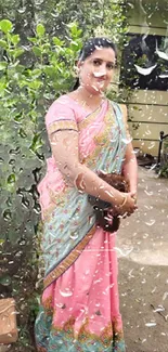 Woman in colorful saree in lush garden setting.