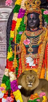 Ornate statue with lion surrounded by colorful flowers.