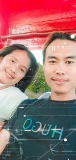 Selfie of a smiling couple under a bright red canopy outdoors.