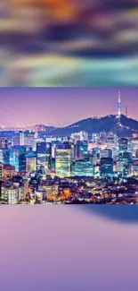 Seoul skyline showing vibrant lights and Namsan Tower with a purple hue.