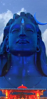 Majestic Shiva statue with celestial blue sky.